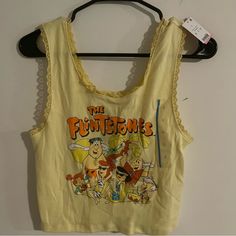 New Women’s Cropped Baby Tank. This Has A Retro Beach Themed Flintstone Design. The Color Is Called Mellow Yellow & Is A Baby Yellow. The Neckline & Straps & Both Lace Lined. Fun Yellow Sleeveless Top, Casual Yellow Tank Top With Graphic Print, Retro Yellow Tank Top For Spring, Yellow Tank Top With Graphic Print For Spring, Yellow Graphic Print Tank Top For Spring, Spring Yellow Tank Top With Graphic Print, Yellow Fitted Y2k Tank Top, Vintage Yellow Top For Beach, Vintage Yellow Top For The Beach