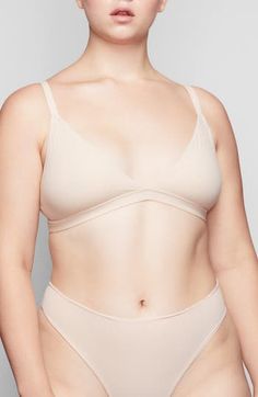 Enjoy the comfort of a bralette while retaining the breathability of quick-dry fabric with this comfortable option from Kim Kardashian West's SKIMS. Available in nine different shades, this second-skin triangle bra offers natural support and comfort while you read, lounge and sleep. Quick-dry, max-stretch technology Lined 79% polyamide, 21% spandex Hand wash, dry flat Imported Lingerie Solid Color Low-cut Sports Bra With Removable Pads, Everyday Seamless Underwire Nursing Bra, Everyday Seamless Underwire Bra, Bra With Removable Pads And Minimal Stretch, Solid Color No-show Bra With Minimal Stretch, Seamless Compressive No-show Bra, Stretch Seamless Underwire Nursing Bra, Seamless Stretch Underwire Nursing Bra, Sports Bra With Removable Pads And Minimal Stretch