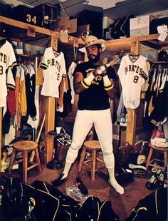 a baseball player is standing in the locker room