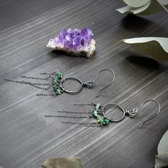 These earrings were created with emerald chips and sterling silver. I created the hoops out of 18 gauge sterling silver, and I created the earwires out of 20 gauge sterling silver.These earrings are 3” long at the longest point and each one weighs 1.4 grams. Green Wire Wrapped Dangle Hoop Earrings, Green Wire-wrapped Dangle Hoop Earrings, Green Long Drop Sterling Silver Jewelry, Nickel-free Green Sterling Silver Hoop Earrings, Green Sterling Silver Small Hoop Jewelry, Green Small Hoop Sterling Silver Jewelry, Green Wire Wrapped Long Drop Jewelry, Sterling Silver Hoop Earrings For May Birthstone, Green Nickel-free Hoop Jewelry