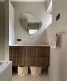 a bathroom with a sink, mirror and bathtub