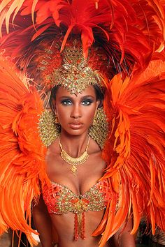 a woman with large orange feathers on her head