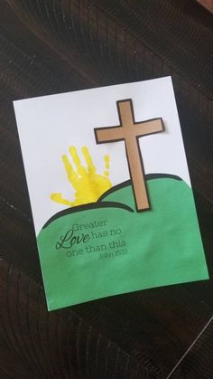 a cross and handprint on a piece of paper with the words jesus loves no one else than this