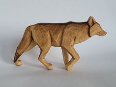 a wooden carving of a bear on a white background