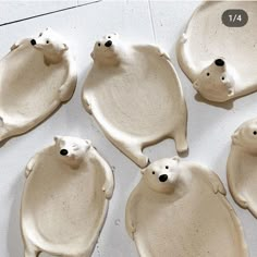 six ceramic polar bears sitting on top of each other in the shape of trays