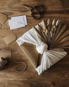 some paper and scissors on a wooden table