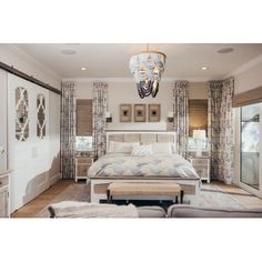 a bedroom with white furniture and curtains