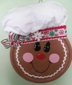 a paper plate with a face on it and a white towel hanging from the top