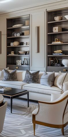 a living room filled with white furniture and lots of bookshelves behind the couch