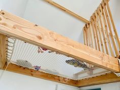 a close up of a wooden stair case in a room with white walls and wood railings