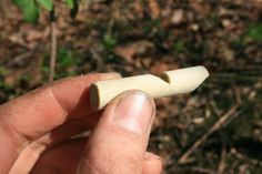 a person holding a piece of wood in their hand