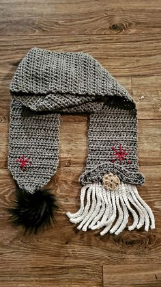 a crocheted hat and scarf on a wooden floor