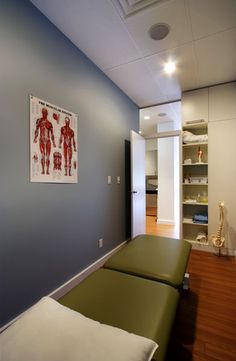 an empty room with two beds in it and shelves on the wall next to them