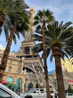 the eiffel tower is surrounded by palm trees