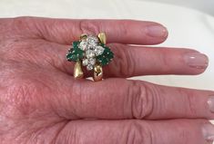 Emerald and diamond cluster ring. 14K yellow gold statement ring has 14 round vibrant green genuine emeralds, & 10 round shimmering diamonds in a free form design across the top of the ring. Below the gemstones is a detailed open airy under gallery. The design is like a bow with the ends being all high polished yellow gold. There is a beautiful rounded shank that tapers on the bottom to 2.5mm. Ring is a size 7 1/2 and can be resized 14 Emeralds app. .75cts have intense green color 10 Diamond Emerald Statement Ring, May Birthstone Rings, Emerald Rings, Gold Statement Ring, Ring Emerald, April May, May Birthstone, Form Design, Diamond Cluster Ring