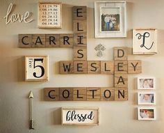 the wall is decorated with wooden scrabbles and framed photos, which spell out their names