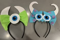 two hair clips with eyes and bows on them