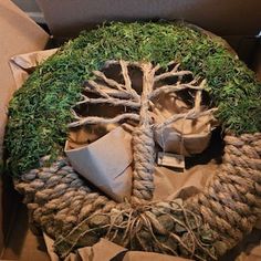 a box that has some kind of tree on it with rope wrapped around the top