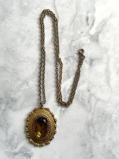 This is: An original vintage pendant necklace by Sarah Coventry in the 60s/70s. Baroque style ornate gold metal pendant with a citrine glass faceted cabochon, and on its original etched-link chain. Good quality and condition - just age-fading to the plating. Length of chain: 25"  / 63cm Pendant size: 4.5 x 3.5cm Any questions, please message me, thanks. ✩Please Remember: When purchasing a vintage item, please be aware that it is an old item with history and individuality. A genuine vintage item Vintage Pendant Necklace, Cabochon Necklace, Sarah Coventry Jewelry, Antique Jewelry Necklace, Style Baroque, 60s Vintage, Sarah Coventry, Baroque Fashion, Metal Pendant