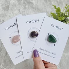 three cards with rocks on them are held by a woman's hand and the card says you rock