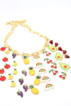 What's cheerier than fruits and rainbows? We've gathered together this delicious little bundle of enamel charms to brighten up your day. Choose your favorite fruit or a rainbow, or choose them all!These mix and match perfectly with our enamel chains and so many other beads. Use a jump ring to add these cheery charms onto a chain or beaded necklace for your daily dose of fruits and rainbows!✨The MAGIC is in the Details✨Charm Size: Apple: 10x15mmBanana: 8x12mmGrapes: 10x14mmPineapple: 10x24mmRainb Playful Charm Necklace With Dangling Charms For Gift, Multicolor Removable Charms For Jewelry Making, Multicolor Charm Necklace With Dangling Charms As Gift, Multicolor Charm Necklaces With Dangling Charms As Gift, Playful Jewelry With Fruit Design For Gift, Cute Multicolor Personalized Charms, Playful Fruit Design Jewelry For Gifts, Cute Multicolor Charms For Gifts, Playful Multicolor Jewelry With Removable Charms