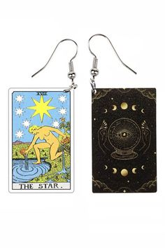 two taroti cards are hanging from earrings