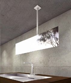 a bathroom with a sink, mirror and light hanging from it's ceiling fixture