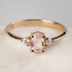 "Morganite and Diamond Ring, 14K Gold Ring, Dainty Morganite Ring, Birthstone Ring, Natural Morganite Ring, Birthday Gift, Mothers Day Gift ♦ SPECIFICATIONS ♦ ▸ Stone Certificate: Comes with Stone Certificate ▸ Made to Order ▸ Custom Gold Color: Yellow Gold, Rose Gold, White Gold ▸ Material: Solid Real Gold (not gold-filled or no gold plated) ▸ Gold Carat: 14K - 585 ▸ Stone-Cut: Oval Cut ▸ Stone dimensions: 6.00mm x 4.00mm ▸ Morganite Stone Carat: 0.38 ctw ▸ Diamond-Cut: Round Cut ▸ Stone dimens Morganite Three Stone Jewelry For Wedding, Morganite Three-stone Wedding Rings, Morganite Three Stone Wedding Rings, Three Stone Morganite Rings For Wedding, Heirloom Morganite Diamond Ring With Gemstone, 14k Gold Cluster Ring With Gemstone Accents As Gift, Rose Gold Heirloom Three Stone Rings, Oval Rose Gold Rings With Gemstone Accents, Heirloom Rose Gold Three Stone Rings