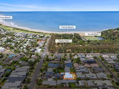 an aerial view of the beachfront with lots of houses and land in front of it