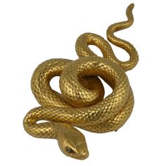 a gold colored snake on a white background