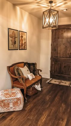 a living room filled with furniture and pictures on the wall next to a wooden door