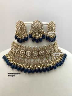 Antique Gold Polki Necklace Set comes with Stud earrings and tikka / Indian Jewelry/ High Quality Kundan and Polki Jewelry/ Bollywood Jewelry/Wedding Jewelry/Navy Blue  All items are shipped from Brampton, Ontario, Canada. If you need your item by a certain day, please reach out to us for express delivery option before placing the order so that we can update the shipping for you. Standard shipping/delivery timeline Below are the delivery timeline estimates once the order ia shipped ---> USA delivery timeline * 3-5 business days to major urban centers in USA. It may take 1-2 days extra to remote locations ---> Canada delivery timeline  * 2-3 business days - GTA  & Montreal  * 2-4  business days - Rest of Ontario/Quebec * 3-6 business days-  Rest of Canada    ---> Europe/Middle East timeline Party Jewelry With Zari Work For Festivals, Blue Bollywood Jewelry Sets For Gift, Blue Bollywood Style Jewelry Sets For Gift, Blue Kundan Necklace For Celebration, Blue Hand Set Necklace For Diwali, Blue Bollywood Jewelry Sets With Stone Work, Bollywood Blue Stone Work Jewelry Sets, Blue Stone Work Jewelry Sets For Wedding, Blue Jewelry Sets With Stone Work For Wedding