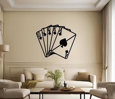 a living room filled with furniture and a wall mounted playing card game decal on the wall