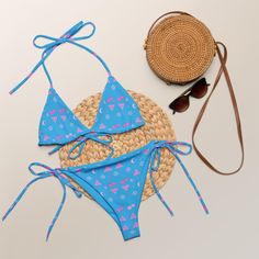 Stay comfortable and stylish all summer with this All-Over Print Recycled String Bikini set. It’s made from soft recycled polyester with double-layering and UPF 50+. Style the straps how you like, and get ready to swim! • Soft and stretchy material with UPF 50+ • Sizes up to 6XL • Bikini top comes with removable padding for comfort • Multiple ways to tie and style the bikini set • Color design options for swimwear lining Disclaimer: To make your All-Over Print Recycled String Bikini last longer, Adjustable Printed Swimwear For Beach, Adjustable Printed Summer Swimwear, Printed Adjustable Summer Swimwear, Adjustable Printed Beachwear Swimwear, Adjustable Printed Swimwear For Poolside, Adjustable Printed Swimwear For Pool, Playful Swimwear With Adjustable Straps For Pool, Adjustable Printed Swimwear For The Pool, Playful Adjustable Strap Swimwear For Pool