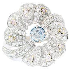 18kt white gold ring with diamonds Gold colour & karat: White gold 18kt Weight: 6.303 grams Set with- Stone type: Diamonds Shape: Round Carat: 0.25 ct Colour: Fancy Blue Clarity: SI Surrounding Stones: Diamonds 1) White Diamonds Carat weight: 0.869 ct (155 pcs) Color: F Clarity: VS1/VS2 Cut: Round 2) Pink Diamonds Carat weight: 0.074 ct (8 pcs) Colour: Fancy Pink Clarity: VS1/VS2 Cut: Round Report type and Number: AGL22080789 Formal Light Blue Diamond Ring, Blue Diamond Ring With Pave Setting In Platinum, Luxury Blue Diamond Ring With Pave Setting, White Diamond Sapphire Ring, Gia Certified, Blue Diamond Rings With Single Cut Diamonds, White Sapphire Diamond Ring Gia Certified, White Sapphire Ring With Gia Certified Diamond, Luxury Blue Diamond Ring With Single Cut Diamonds, Blue Diamond Ring With Single Cut Diamonds