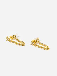 DESCRIPTION:Drop stud earrings with a dainty tennis chain and cubic zirconia stones.FEATURES:Drop EarringsCubic Zirconia Stones14k Gold Plated BrassPost Back ClosureFor Pierced EarsOne Size Tennis Chain, Saint Bernard, Ear Piercings, Cubic Zirconia, Tennis, Gold Plate, Plating, Stud Earrings, Drop Earrings