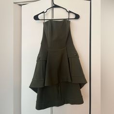 a green dress hanging on a hanger