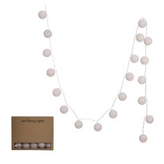 a necklace with white beads on it and a card in front of the chain that says led string lights