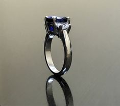 Dekara Designs Collection Metal- 90% Platinum, 10% Iridium. Stones- 1 Natural Untreated 3.88 Carat Oval Cut Ceylon Blue Sapphire. 2 Moon Cut Diamonds, F-G Color VS1 Clarity 0.77 total carats This ring is a size 6, but could be sized up or down a few sizes. This ring could be made in your specific size within 5-10 business days. Could take a little more time due to the ceylon sapphire being a rare stone. The sapphire may be a bit smaller or bigger. We can make the same design in a smaller or bigg Blue Sapphire Emerald Cut Promise Ring, Blue Tanzanite Promise Ring, Blue Sapphire Solitaire Ring Emerald Cut, Blue Solitaire Sapphire Ring Emerald Cut, Blue Solitaire Emerald Cut Sapphire Ring, Modern Blue Sapphire Ring For Formal Occasions, Blue Solitaire Lab-created Sapphire Rings, Classic Blue Rings With Lab-created Sapphire, Blue Rings With Prong Setting For Promise