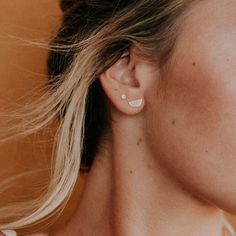 a close up of a person with ear piercings on their ears and one behind the ear