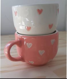 two pink and white cups with hearts on them