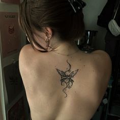 a woman with a tattoo on her back