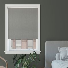 a bedroom with a bed, plant and window blinds in shades on the windowsill