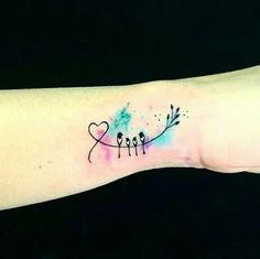 a small tattoo on the wrist that has arrows and hearts painted on it with watercolors