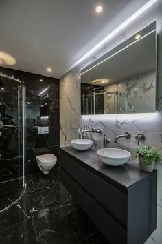 a bathroom with two sinks and a large mirror on the wall next to each other