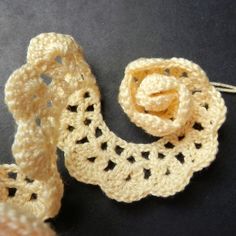 two crocheted pieces of cloth on a table