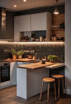 a kitchen with two stools in front of the counter and an island that has plants on it