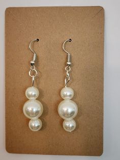 These dazzling dangles bring a sense of timeless class to your ensemble. Pearl White Round Beads Earrings, Elegant Beaded Dangle Clip-on Earrings, Pearl White Round Beaded Earrings, Pearl Beaded Drop Earrings, Elegant Round Bead Clip-on Earrings For Party, Formal Beaded Dangle Earrings, Elegant Beaded Earrings For Party, Formal Beaded Drop Earrings, Elegant Party Clip-on Earrings With Round Beads