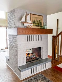 a white brick fireplace with a sailboat on top