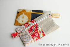 three zippered pouches sitting next to each other on top of a white surface